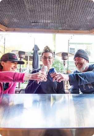 WEDC_SW_WI_LO_RES_219_2d28938652 Three friends cheers at an outdoor patio.
